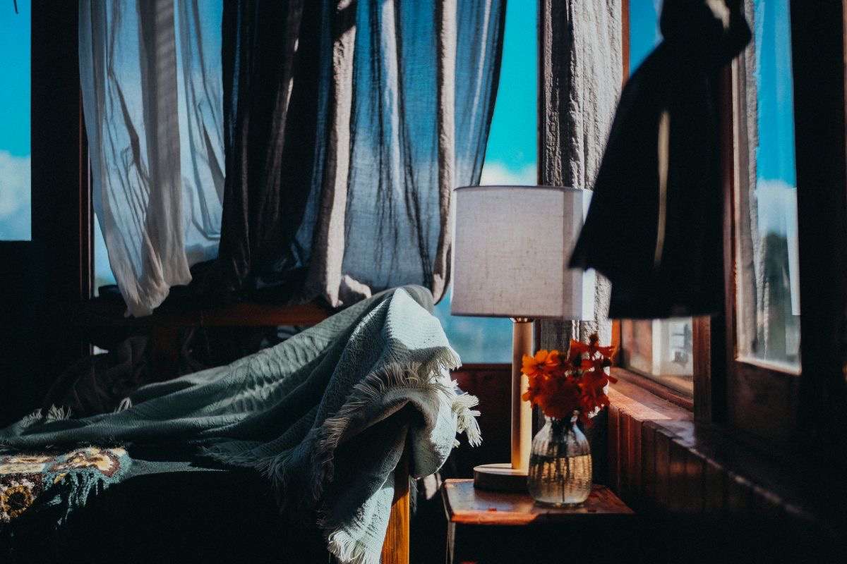 A lamp-lit room at the end of the day
